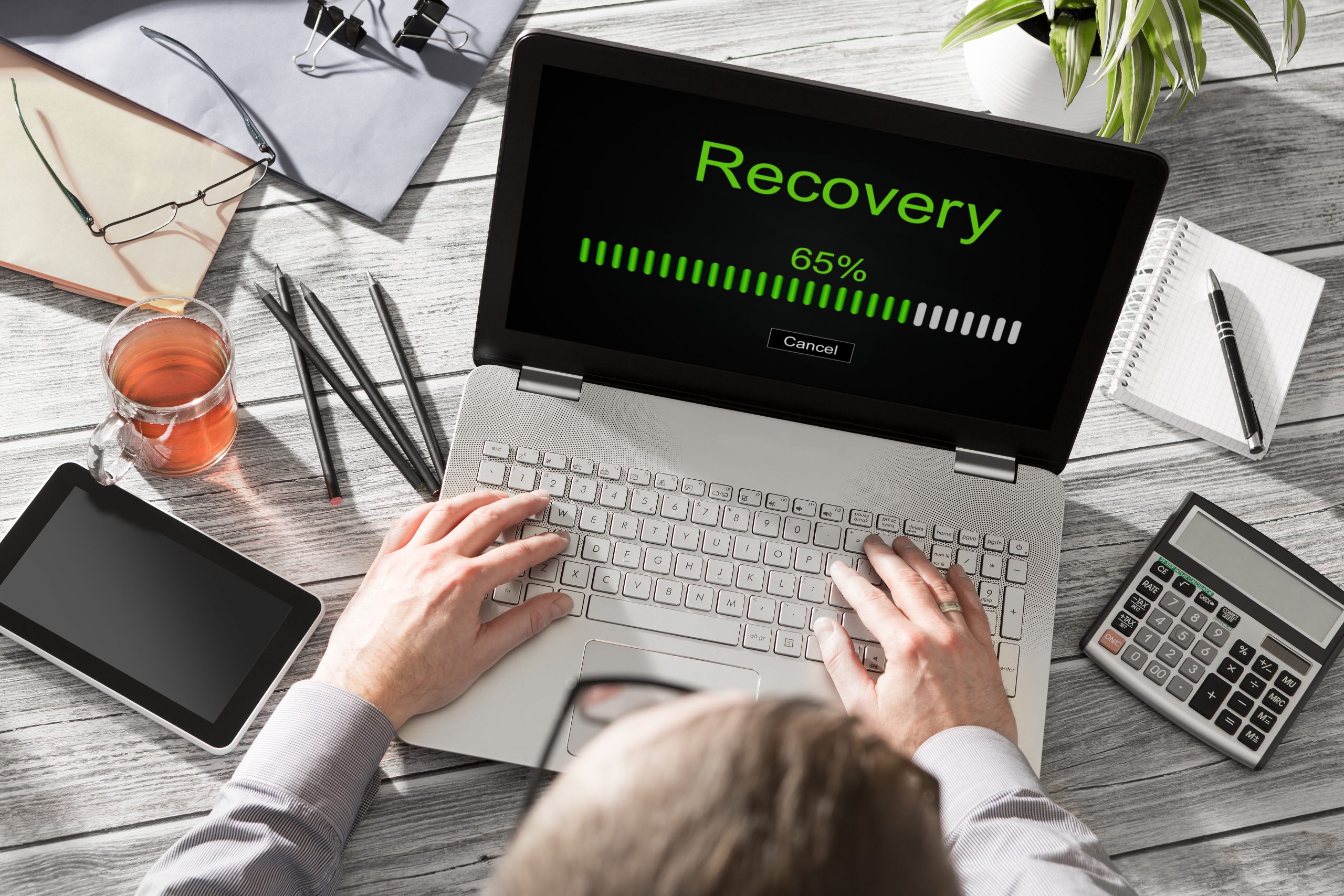Picture of a laptop with the word recovery on the screen