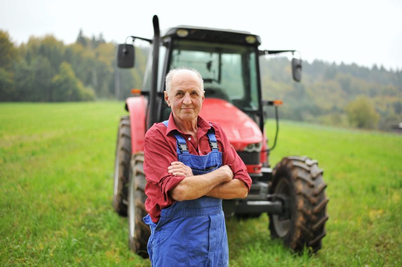 male farmer with his tractor in a field