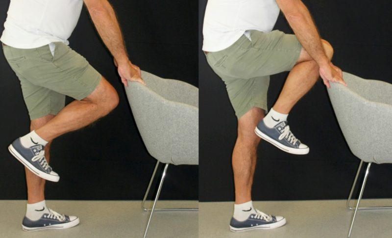 man stood behind a chair with right leg bent upwards to a 90 degree angle